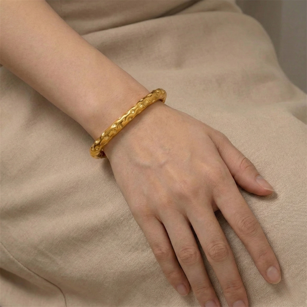 Radiant Resilience: Gold-Plated Hammered Stainless Steel Bracelet